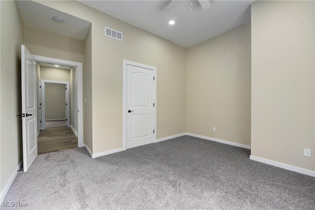 carpeted empty room with visible vents, recessed lighting, and baseboards