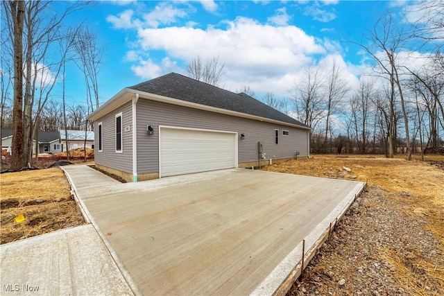 view of side of home featuring driveway