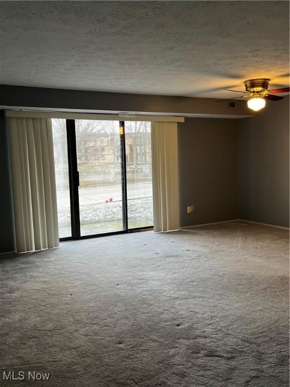 unfurnished room featuring carpet flooring, a textured ceiling, and ceiling fan