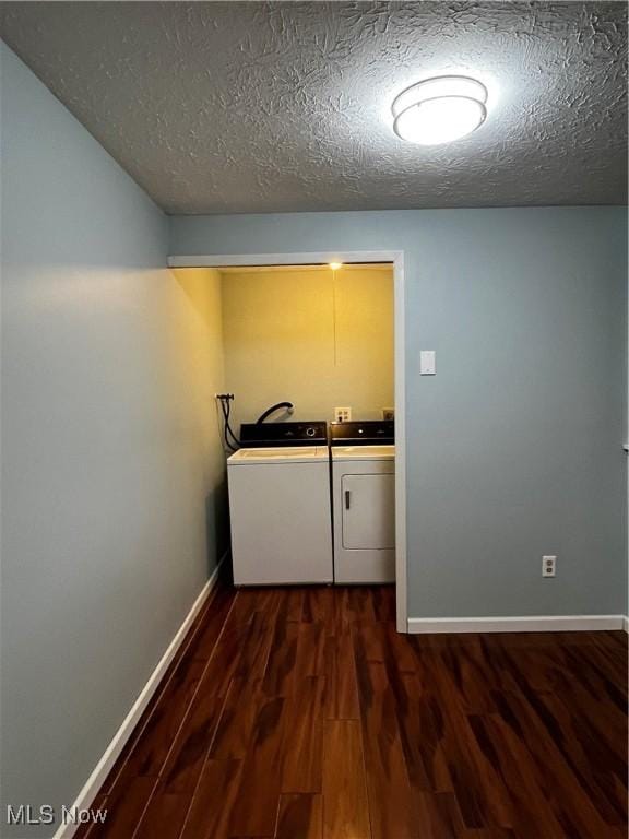 laundry area featuring independent washer and dryer, a textured ceiling, dark wood finished floors, baseboards, and laundry area