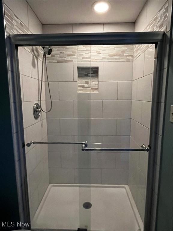 full bath featuring a shower stall