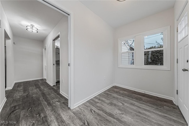 hall with baseboards and dark wood-style flooring