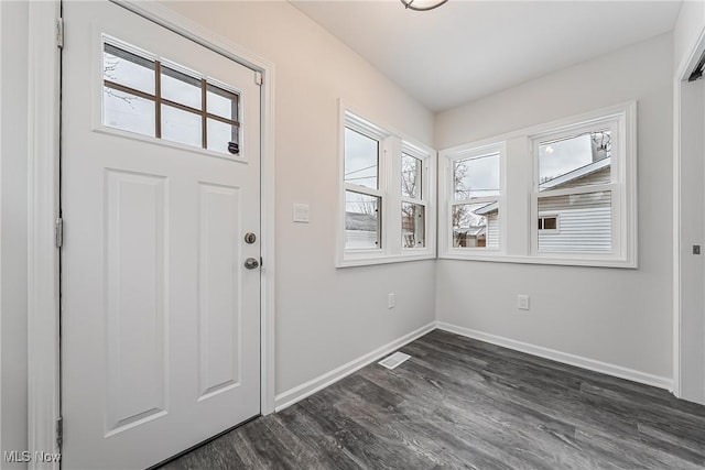 entrance foyer with visible vents, baseboards, and dark wood-style flooring