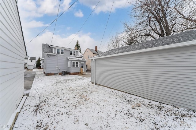 rear view of property featuring a shingled roof