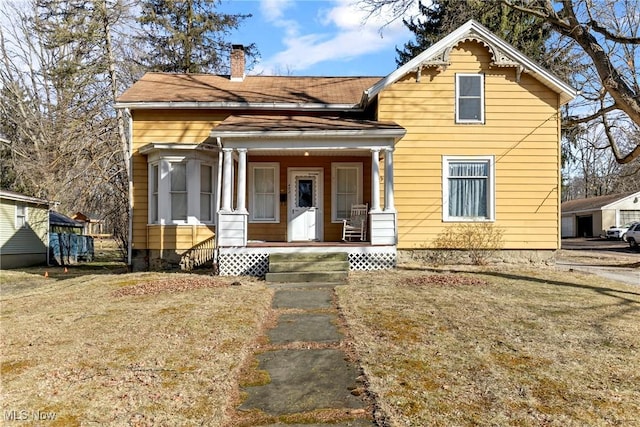 view of front of house featuring covered porch and a chimney