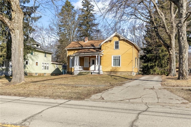 view of front of house with a porch and a chimney