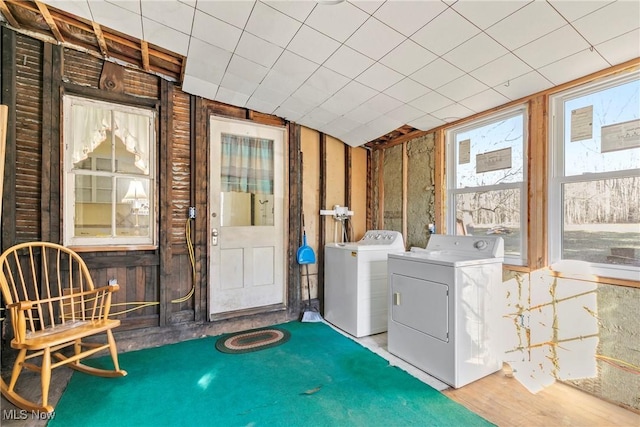 washroom featuring separate washer and dryer, wood finished floors, and laundry area