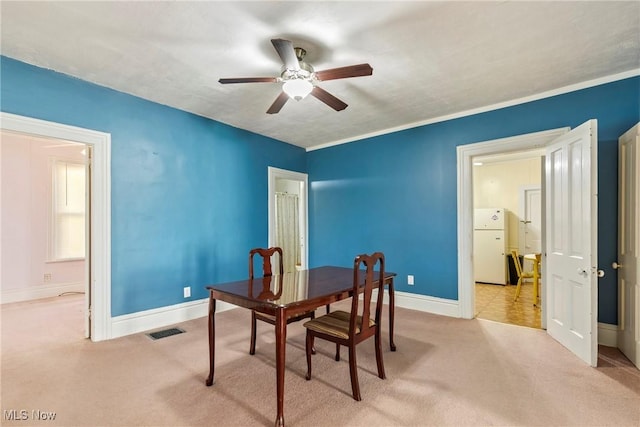 dining room with visible vents, baseboards, carpet, and ceiling fan