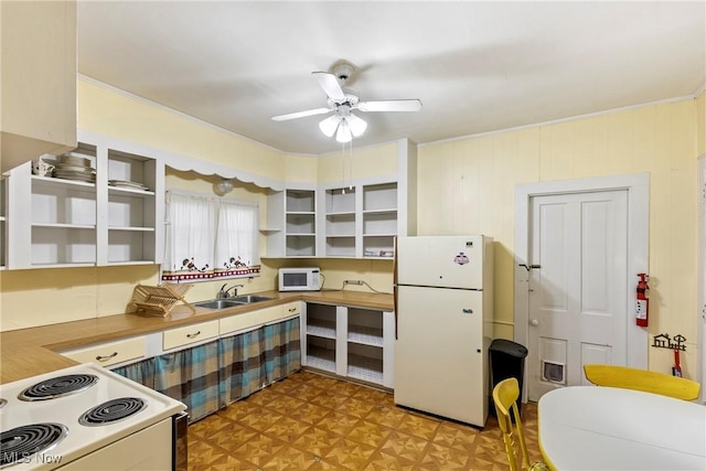 kitchen with white appliances, light floors, open shelves, and a sink