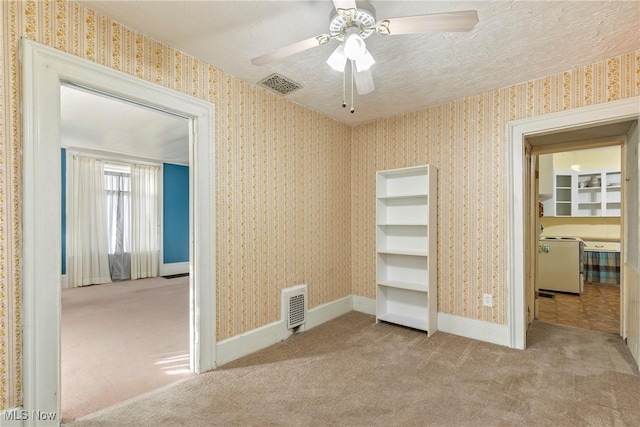 unfurnished bedroom with wallpapered walls, carpet, and visible vents