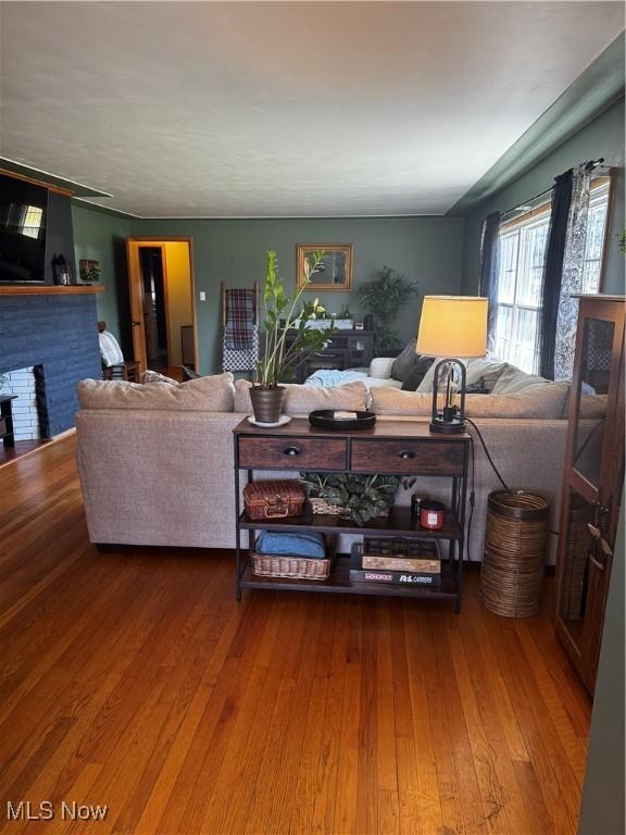 living area with wood finished floors and a fireplace