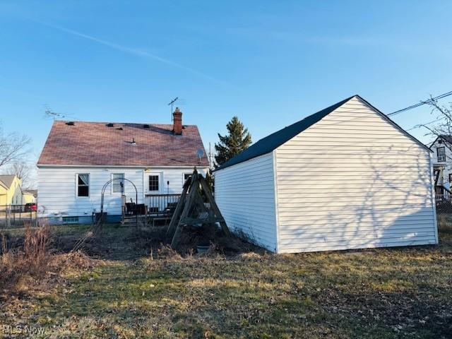 rear view of property featuring a chimney