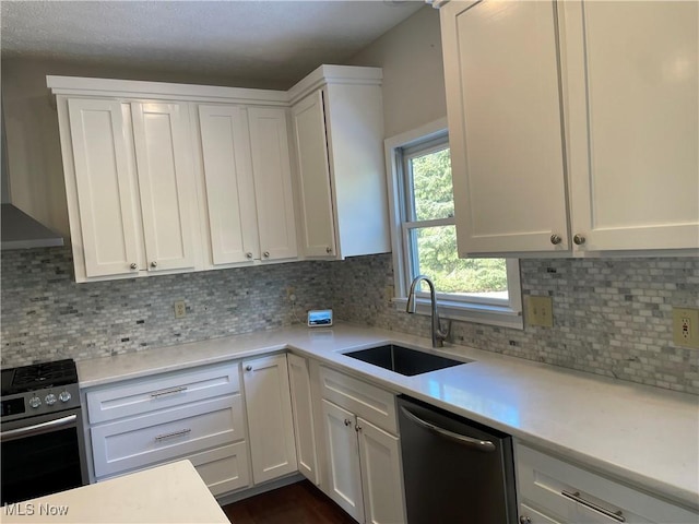 kitchen with white cabinetry, a sink, light countertops, dishwasher, and gas range