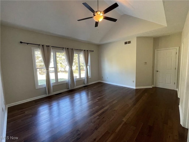 spare room featuring visible vents, high vaulted ceiling, a ceiling fan, dark wood-style floors, and baseboards