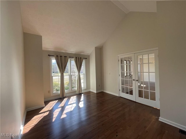 unfurnished room with dark wood-style floors, french doors, baseboards, and a textured ceiling