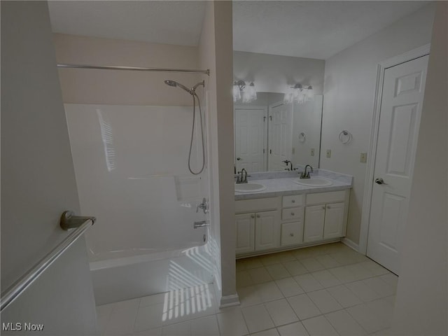 full bath with tile patterned flooring, tub / shower combination, double vanity, and a sink