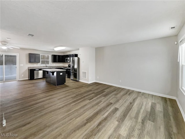 kitchen with visible vents, wood finished floors, appliances with stainless steel finishes, and open floor plan