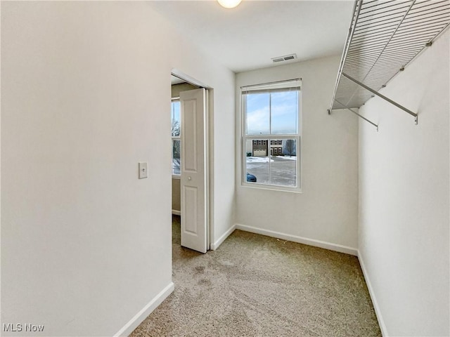 walk in closet with light carpet and visible vents