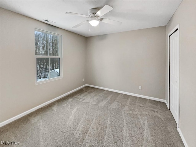 unfurnished bedroom with visible vents, baseboards, ceiling fan, carpet flooring, and a closet