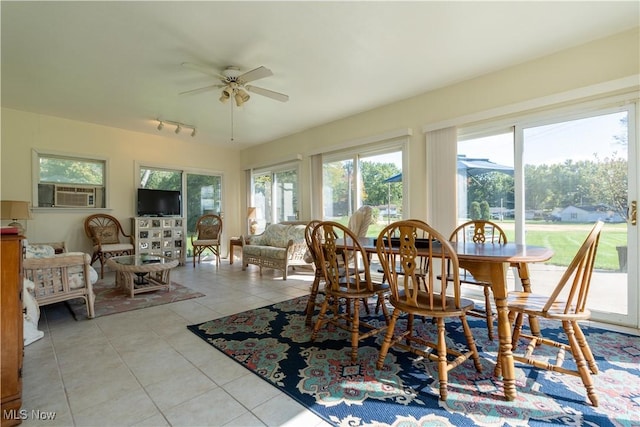 sunroom / solarium featuring plenty of natural light, cooling unit, and ceiling fan