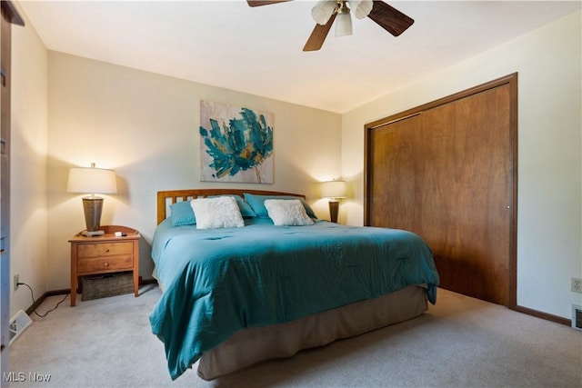 bedroom featuring ceiling fan, visible vents, a closet, and light carpet