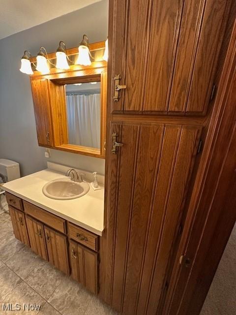 bathroom with tile patterned floors and vanity