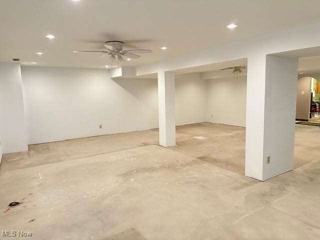 finished below grade area with a ceiling fan and recessed lighting