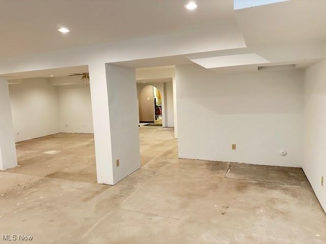 below grade area with arched walkways and recessed lighting
