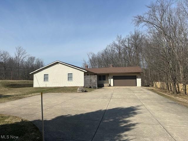single story home featuring an attached garage and driveway