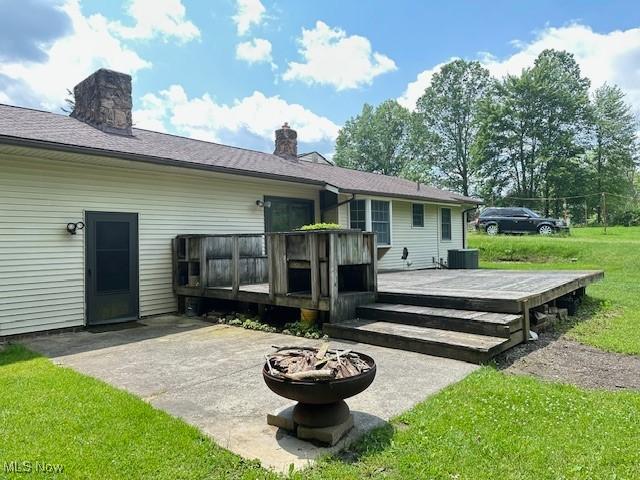 2364 W Royalton Rd, Broadview Heights, OH 44147 - back of property featuring a fire pit, a patio area, a deck, a lawn, and a chimney