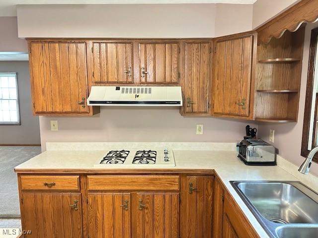 2364 W Royalton Rd, Broadview Heights, OH 44147 - kitchen featuring ventilation hood, open shelves, white gas stovetop, light countertops, and brown cabinetry