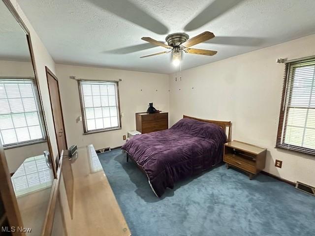 2364 W Royalton Rd, Broadview Heights, OH 44147 - carpeted bedroom with a textured ceiling and ceiling fan