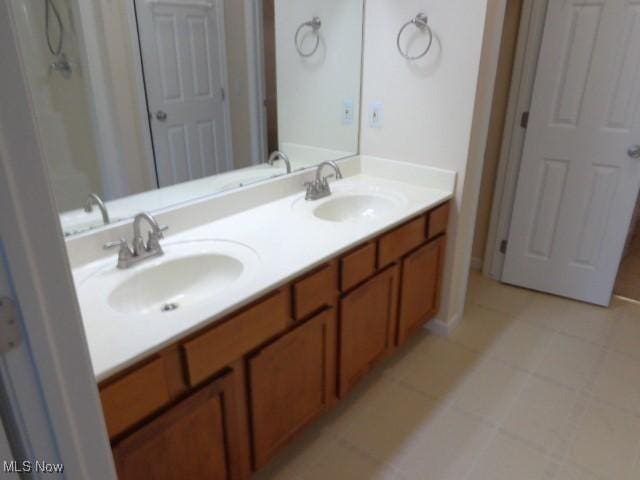 full bath with a sink and double vanity