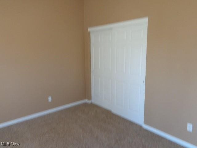 unfurnished bedroom with baseboards and carpet floors