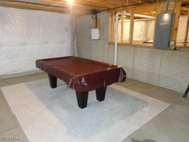 rec room featuring electric panel, concrete flooring, and billiards