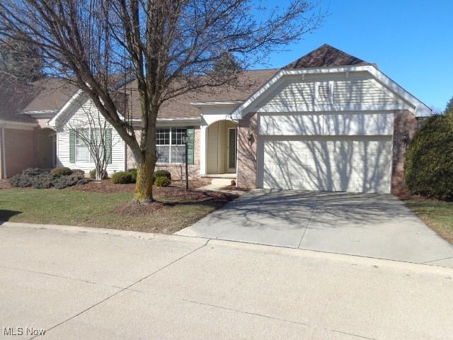 single story home with a garage and driveway