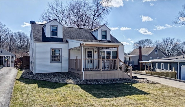 cape cod-style house featuring a porch, a front yard, and roof with shingles