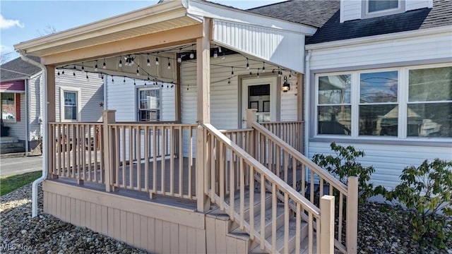 property entrance with a shingled roof