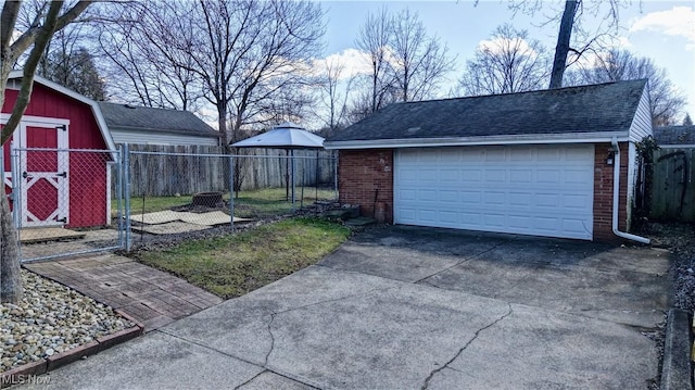 detached garage featuring fence