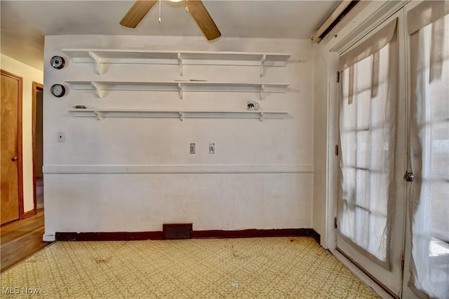 unfurnished room featuring a ceiling fan, baseboards, and a wealth of natural light