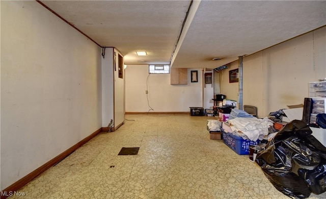 below grade area featuring tile patterned floors and baseboards