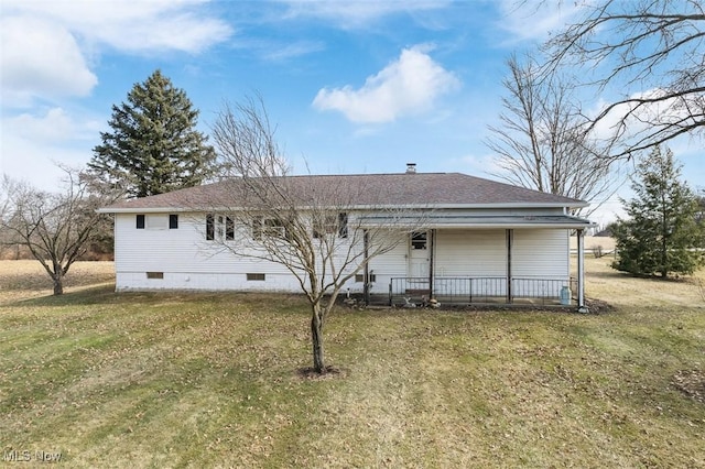 back of property featuring a yard, covered porch, roof with shingles, and crawl space