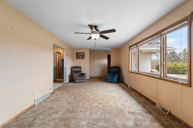 unfurnished room with carpet flooring, baseboards, visible vents, and ceiling fan