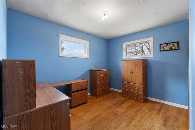 office area featuring a wealth of natural light, baseboards, and light wood-style flooring