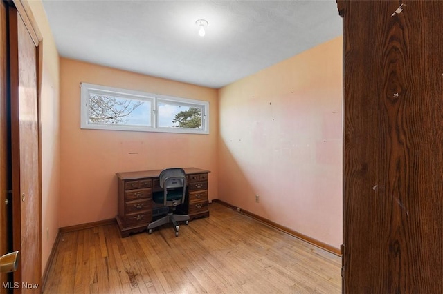 office with light wood-style flooring and baseboards