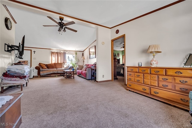 living room with lofted ceiling, ornamental molding, carpet floors, baseboards, and ceiling fan