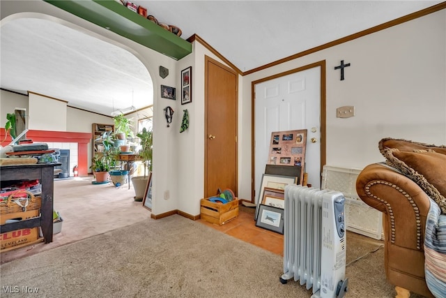 game room featuring ornamental molding, radiator heating unit, carpet floors, arched walkways, and lofted ceiling