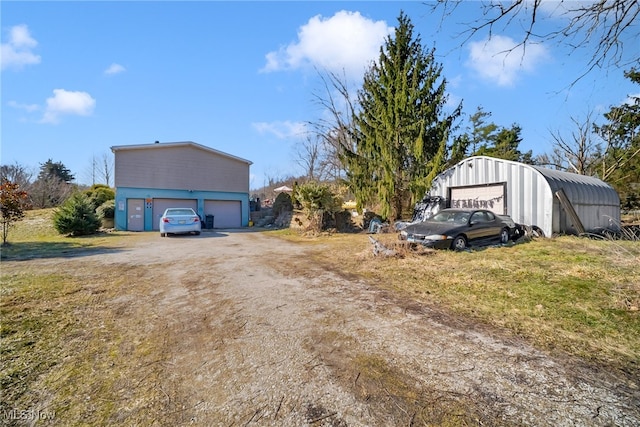 view of property exterior with an outbuilding and a garage