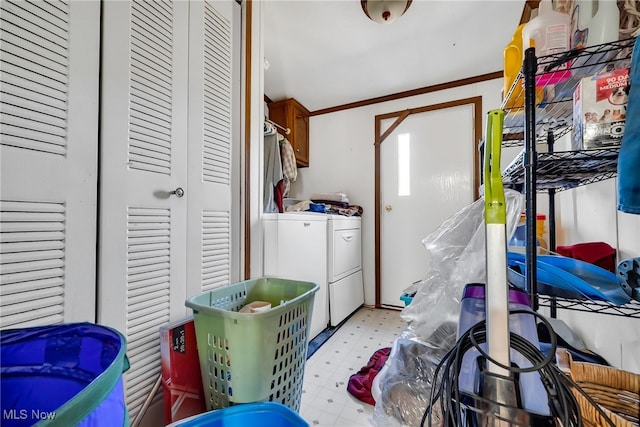 clothes washing area with cabinet space, separate washer and dryer, and light floors