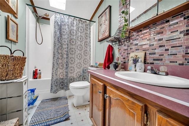 full bathroom with vanity, toilet, brick wall, and shower / tub combo